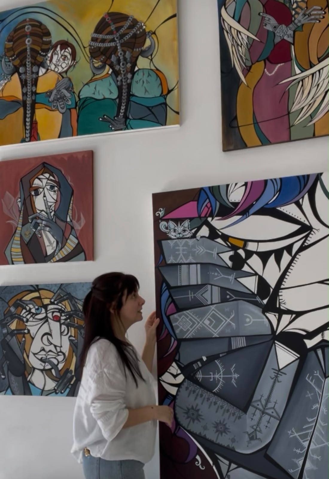 Fadwa Morabet in her studio, beside her paintings